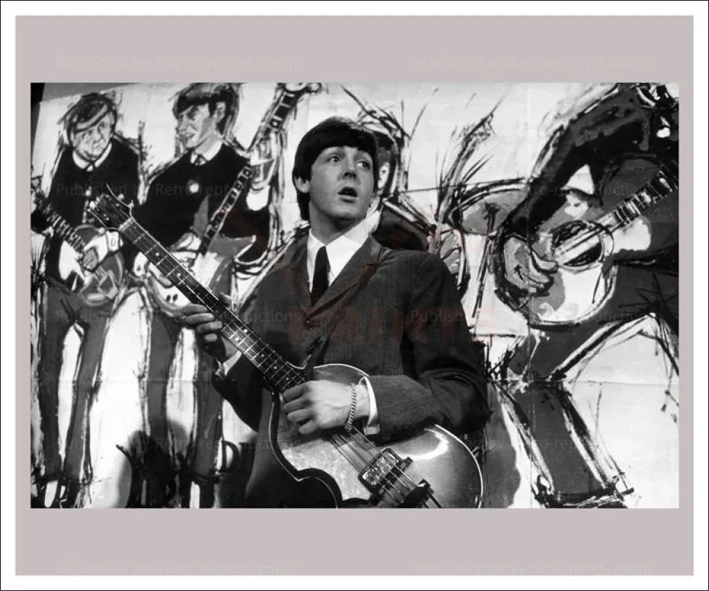 Paul McCartney in front of Beatles Painting - VINTAGEARTREPRINTS.COM